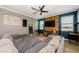 Comfortable living room featuring a rustic wood accent wall, tile floors, and a ceiling fan at 14008 Lugano Ct, Hudson, FL 34669