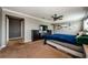 A spacious main bedroom with neutral gray walls, ceiling fan, and an en-suite bathroom at 14008 Lugano Ct, Hudson, FL 34669