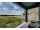 Covered patio with peaceful backyard view and space for outdoor seating at 14008 Lugano Ct, Hudson, FL 34669