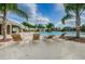 Relaxing pool area with lounge chairs under sunny skies and palm trees at 14008 Lugano Ct, Hudson, FL 34669