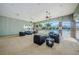 Covered poolside patio featuring seating, ceiling fans, stone pillars, and community pool view at 14008 Lugano Ct, Hudson, FL 34669