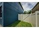 Fenced side yard with lush green grass and a gate to the backyard at 14008 Lugano Ct, Hudson, FL 34669