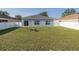 Backyard featuring green grass, back patio, white fence, and place for a fire pit at 15159 Durango Cir, Brooksville, FL 34604