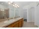 Bathroom featuring a double sink vanity, large mirror, and glass shower at 15159 Durango Cir, Brooksville, FL 34604