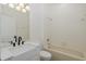 Bathroom features a bright vanity, sink, and white tile tub at 15159 Durango Cir, Brooksville, FL 34604