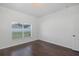 Bedroom with hardwood floors, large window, and bright lighting at 15159 Durango Cir, Brooksville, FL 34604