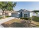 Inviting home featuring a two-car garage and a manicured lawn with decorative landscaping at 15159 Durango Cir, Brooksville, FL 34604