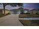 Charming single-Gathering home featuring a two-car garage, well-manicured lawn, and a welcoming facade at 15159 Durango Cir, Brooksville, FL 34604