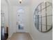 Entryway with tiled flooring, decorative mirror, and an elegant glass-paneled front door at 15159 Durango Cir, Brooksville, FL 34604