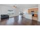 Open concept living room featuring adjacent kitchen, hardwood floors, and natural light at 15159 Durango Cir, Brooksville, FL 34604