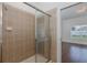 Tiled shower with glass doors and chrome hardware in the bathroom at 15159 Durango Cir, Brooksville, FL 34604