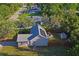 Home aerial view featuring solar panels, large lot, shed and fenced backyard at 15613 Charmwood Dr, Hudson, FL 34667