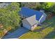 Aerial view of home featuring a large driveway and mature landscaping at 15613 Charmwood Dr, Hudson, FL 34667
