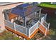 Elevated view of the deck showing a gazebo, outdoor dining table, and backyard access at 15613 Charmwood Dr, Hudson, FL 34667