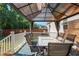 Covered back deck with a dining table, chairs, and string lights for outdoor enjoyment at 15613 Charmwood Dr, Hudson, FL 34667