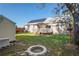 Spacious backyard featuring a patio, storage shed, and solar panels on the roof at 15613 Charmwood Dr, Hudson, FL 34667