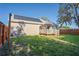 Wide backyard with fire pit, patio, lush lawn, and home featuring solar panels at 15613 Charmwood Dr, Hudson, FL 34667