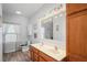 Well-lit bathroom featuring double sinks, a spacious vanity, and neutral wall paint at 15613 Charmwood Dr, Hudson, FL 34667