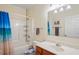 Bathroom featuring neutral walls, a tub-shower, and a wood vanity with ample storage at 15613 Charmwood Dr, Hudson, FL 34667