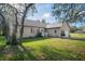Well-maintained single Gathering home with a green lawn and mature landscaping, featuring a side entry garage at 15613 Charmwood Dr, Hudson, FL 34667