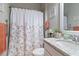 Stylish bathroom featuring a floral shower curtain, granite vanity, and soft lighting for a relaxing ambiance at 16697 Courtyard Loop, Land O Lakes, FL 34638