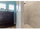 This primary bathroom features a shower with beautiful tile surround at 16697 Courtyard Loop, Land O Lakes, FL 34638