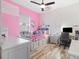 This pink bedroom features a ceiling fan, plush carpet, and natural light from the window at 16697 Courtyard Loop, Land O Lakes, FL 34638
