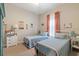 Neutral bedroom with two twin beds, side tables, and colorful decor offering a calm and inviting space at 16697 Courtyard Loop, Land O Lakes, FL 34638