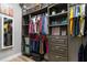 Walk in closet with custom shelves and racks to keep your wardrobe organized at 16697 Courtyard Loop, Land O Lakes, FL 34638