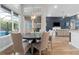Bright dining room with a round table, stylish light fixture, and views of the pool at 16697 Courtyard Loop, Land O Lakes, FL 34638