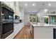 Modern kitchen with updated appliances and a view into the dining area and backyard at 16697 Courtyard Loop, Land O Lakes, FL 34638