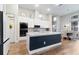 Gorgeous kitchen featuring a large center island, pendant lighting, and modern appliances at 16697 Courtyard Loop, Land O Lakes, FL 34638