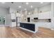 Modern kitchen with white cabinets, granite countertops, and stainless steel appliances at 16697 Courtyard Loop, Land O Lakes, FL 34638