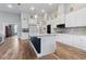 Open-concept kitchen with an island, granite countertops, and modern appliances at 16697 Courtyard Loop, Land O Lakes, FL 34638