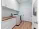 Functional laundry room with ample storage, washer, and dryer at 16697 Courtyard Loop, Land O Lakes, FL 34638