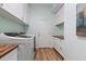 Bright laundry room with a washer, dryer, and plenty of counter space and cabinets at 16697 Courtyard Loop, Land O Lakes, FL 34638