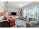 Cozy living room with a red sofa, exercise bike, and a large television for entertainment at 16697 Courtyard Loop, Land O Lakes, FL 34638