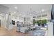 Spacious living room features a plush sectional sofa and a view of the pool at 16697 Courtyard Loop, Land O Lakes, FL 34638