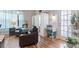 A comfortable living room featuring hardwood floors, neutral tones and a quaint work space at 16697 Courtyard Loop, Land O Lakes, FL 34638
