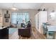 Inviting living room with wood floors, comfortable seating, natural light, and a small desk area at 16697 Courtyard Loop, Land O Lakes, FL 34638