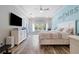 Bright main bedroom features tray ceilings, hardwood floors, and a large window for natural light at 16697 Courtyard Loop, Land O Lakes, FL 34638