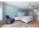Airy main bedroom with en-suite, featuring a comfortable bed and ample lighting at 16697 Courtyard Loop, Land O Lakes, FL 34638