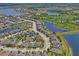 Picturesque aerial view showcases a thriving community with ponds and verdant green spaces at 1760 Fox Grape Loop, Lutz, FL 33558