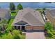 Aerial view of a beautiful home with a well-manicured lawn, paver driveway and view of the lake at 1760 Fox Grape Loop, Lutz, FL 33558