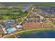 An aerial view displays the community's playground, tennis courts, and refreshing pool area at 1760 Fox Grape Loop, Lutz, FL 33558