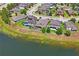 Beautiful backyard with a swimming pool and outdoor seating, complemented by lush landscaping and a serene lake view at 1760 Fox Grape Loop, Lutz, FL 33558