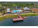 Aerial view of community amenities including a pool, clubhouse, tennis courts, and pier at 1760 Fox Grape Loop, Lutz, FL 33558
