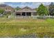 Backyard featuring a pergola covered patio, screened in lanai, well-manicured lawn, and a white picket fence at 1760 Fox Grape Loop, Lutz, FL 33558