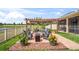 Inviting backyard patio with a fire pit, comfortable seating, and a view of the surrounding greenery at 1760 Fox Grape Loop, Lutz, FL 33558