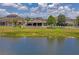 Back view of the home with a beautiful backyard, screened in patio, pergola, and a white picket fence at 1760 Fox Grape Loop, Lutz, FL 33558